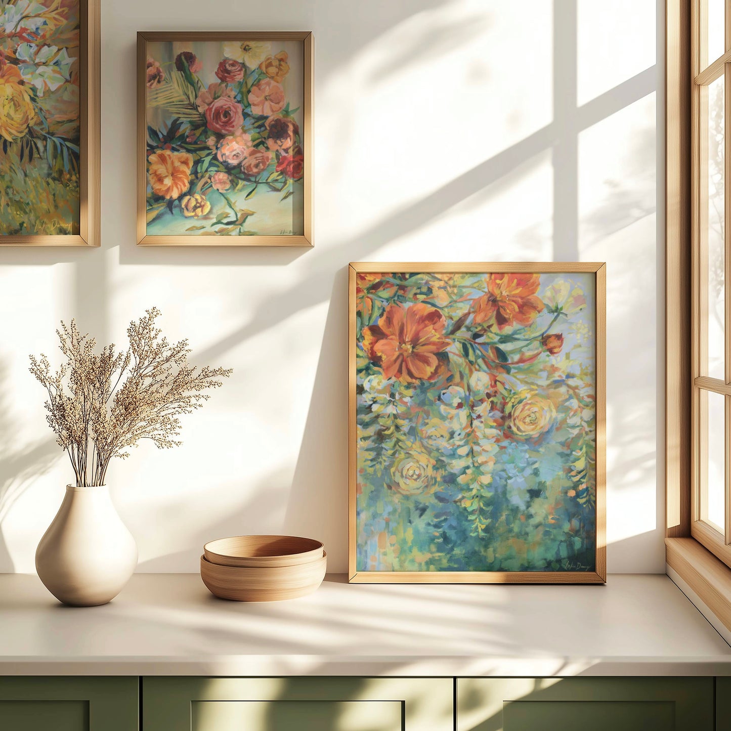 Framed abstract floral artwork on a wall with natural light
