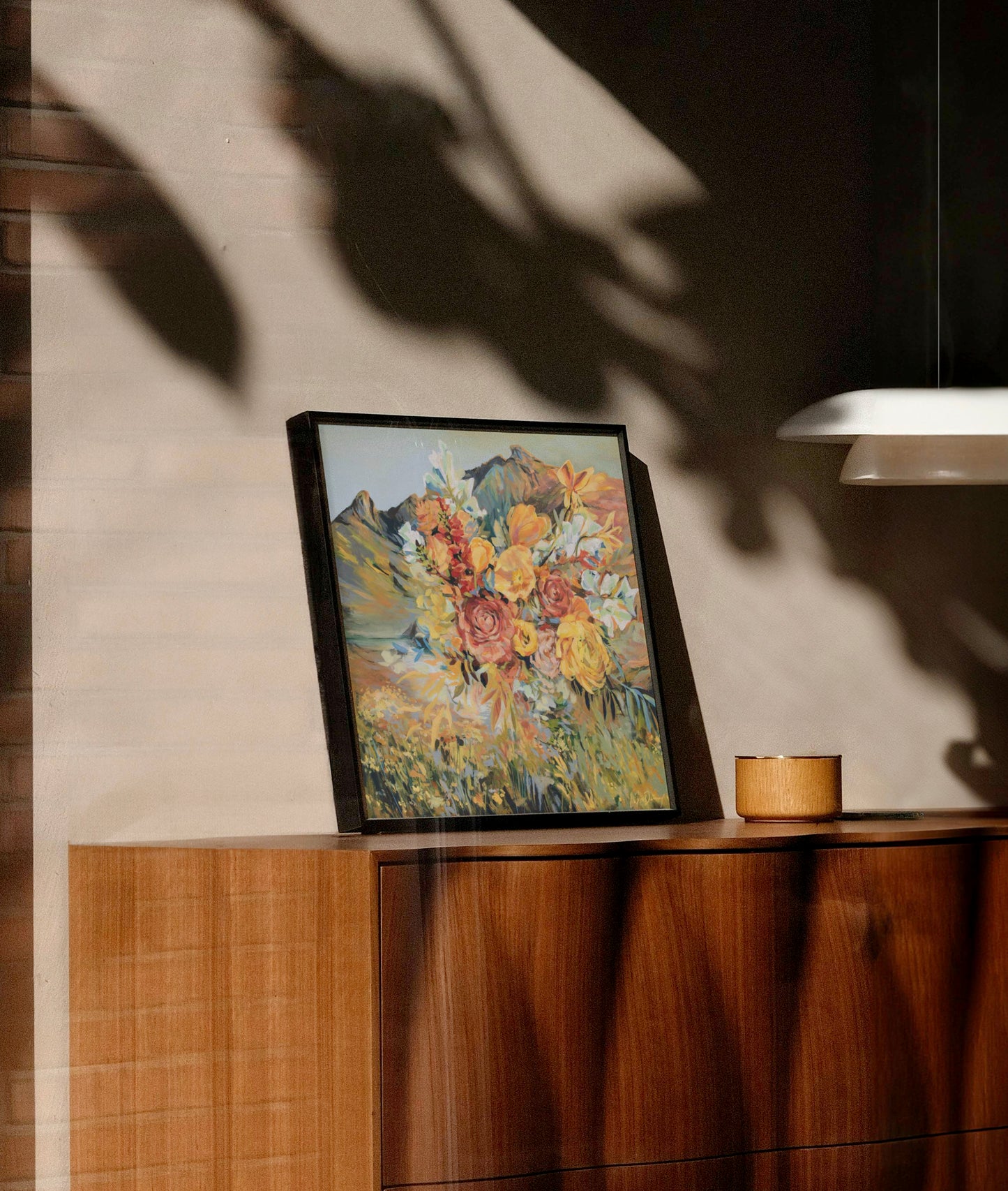 Framed artwork on a wooden surface with a neutral background