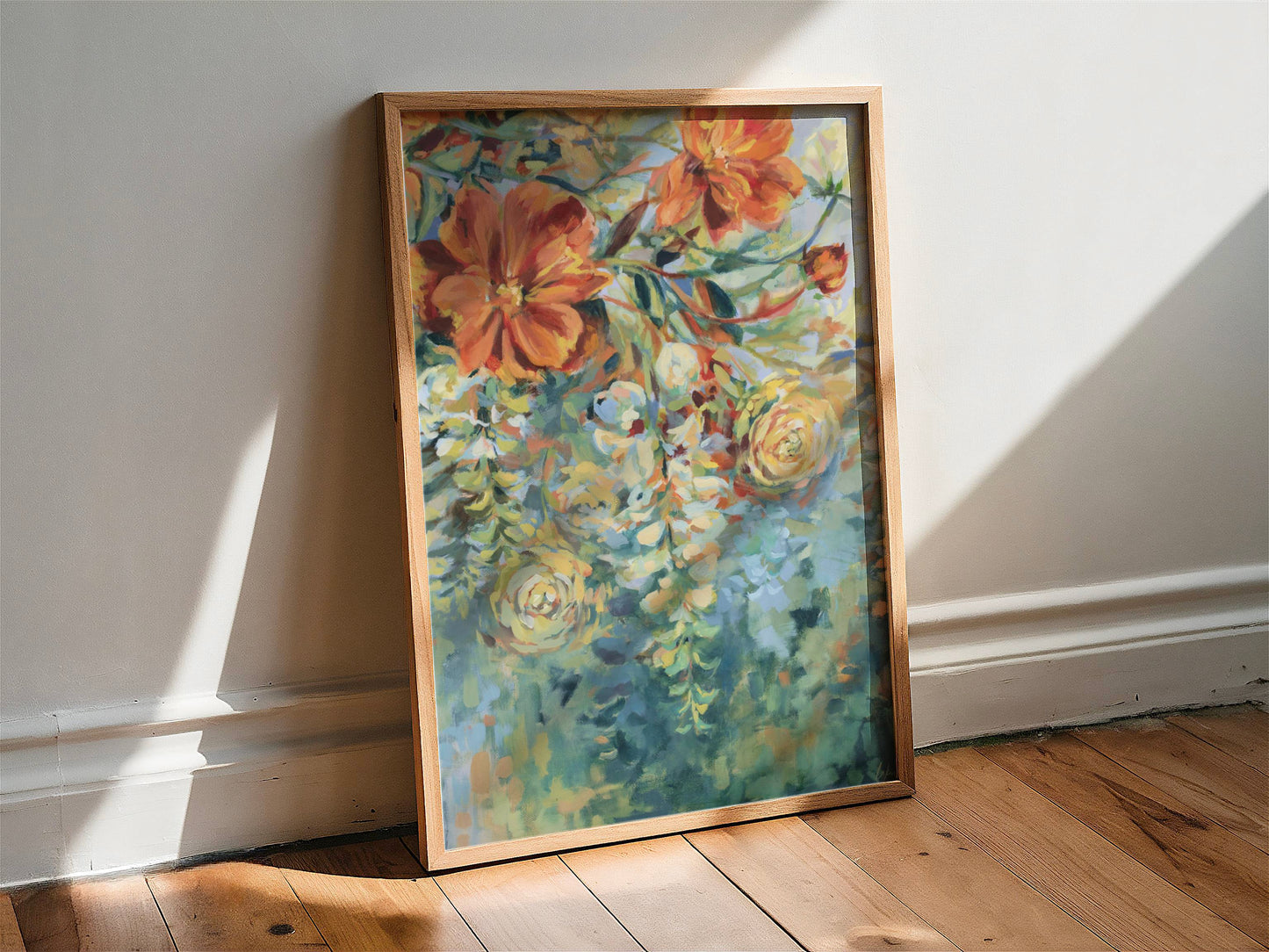 Framed floral painting on a wooden floor with sunlight casting shadows.