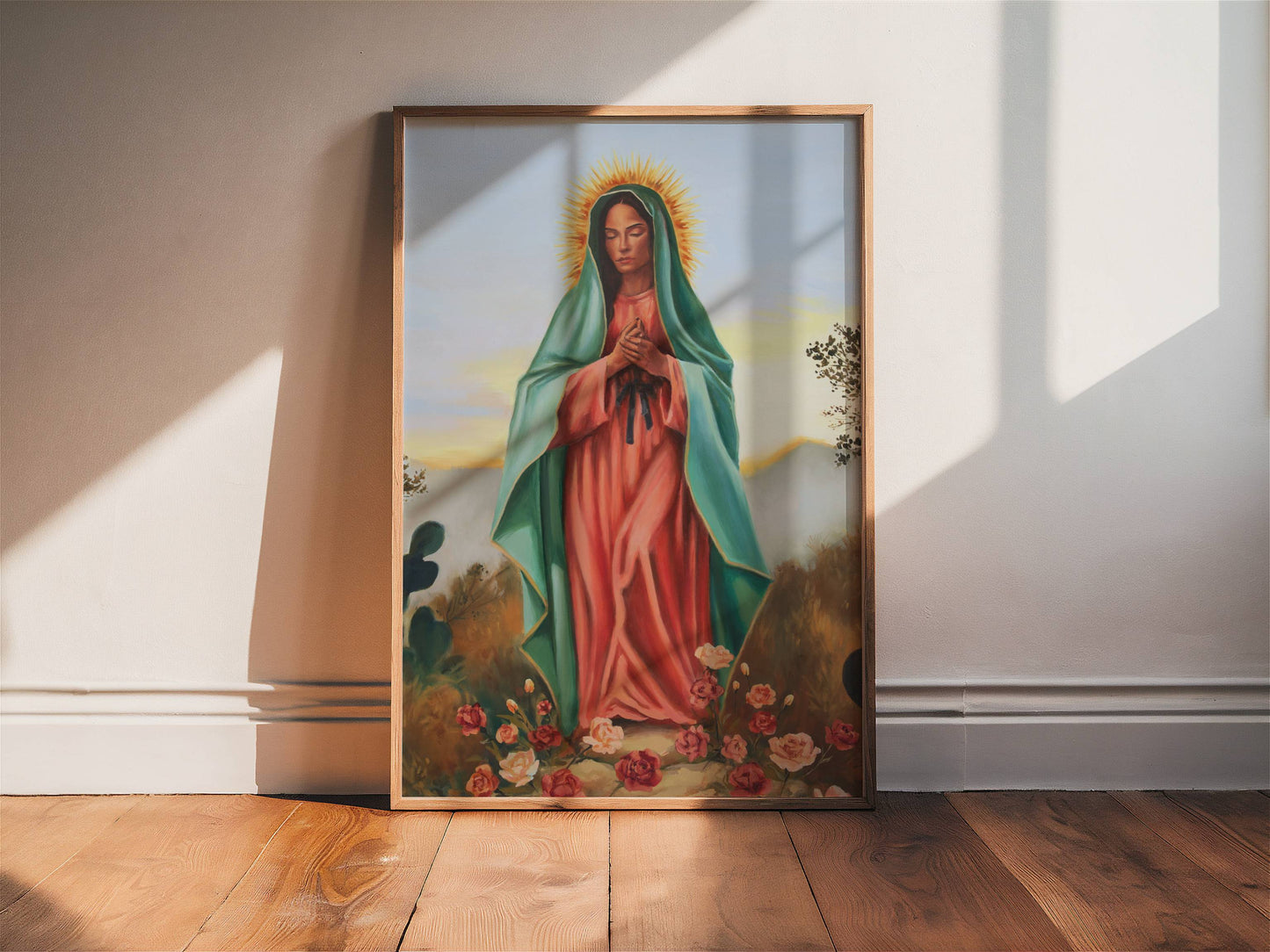 Framed painting of a religious figure on a wooden floor with sunlight casting shadows.