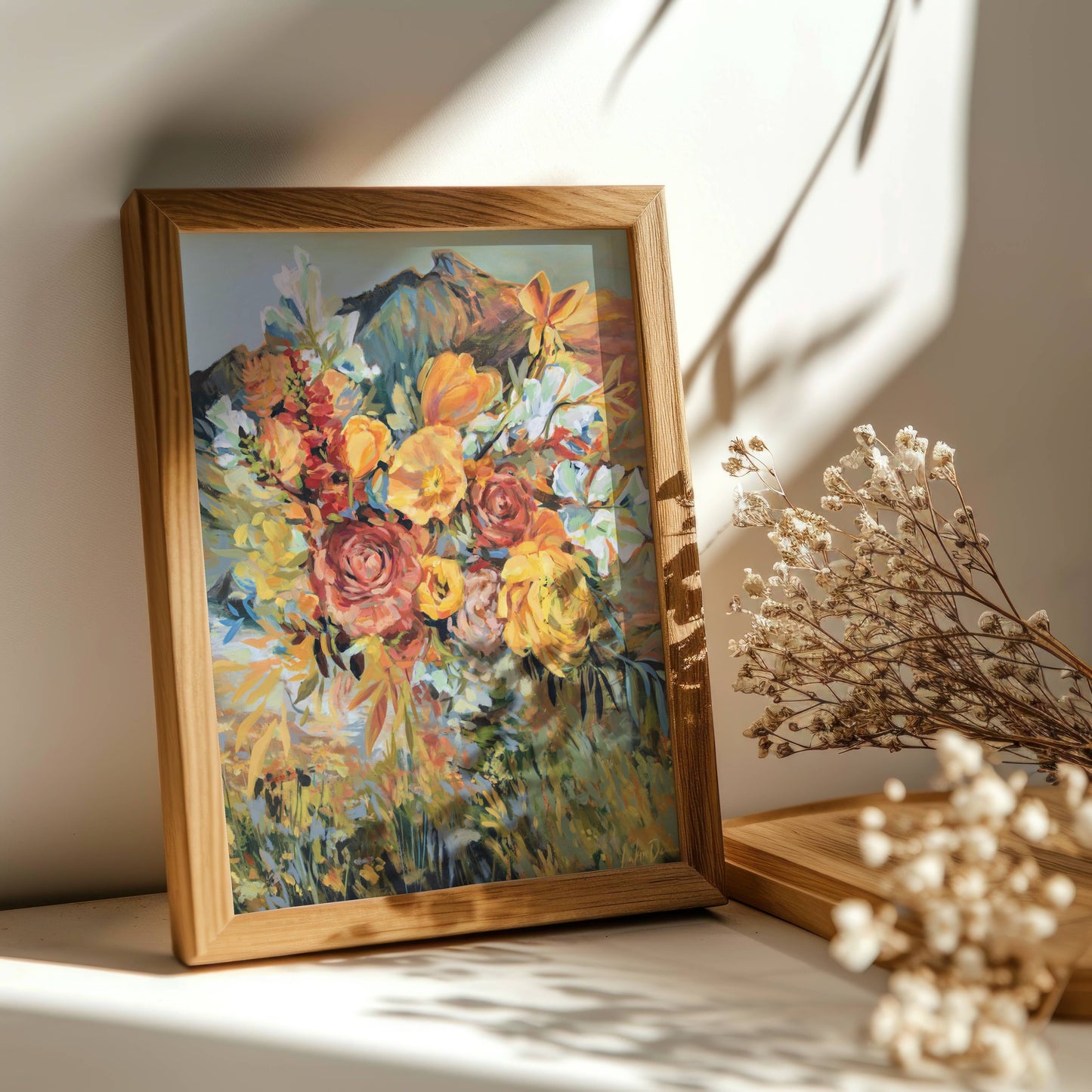 Framed painting of flowers on a surface with natural light