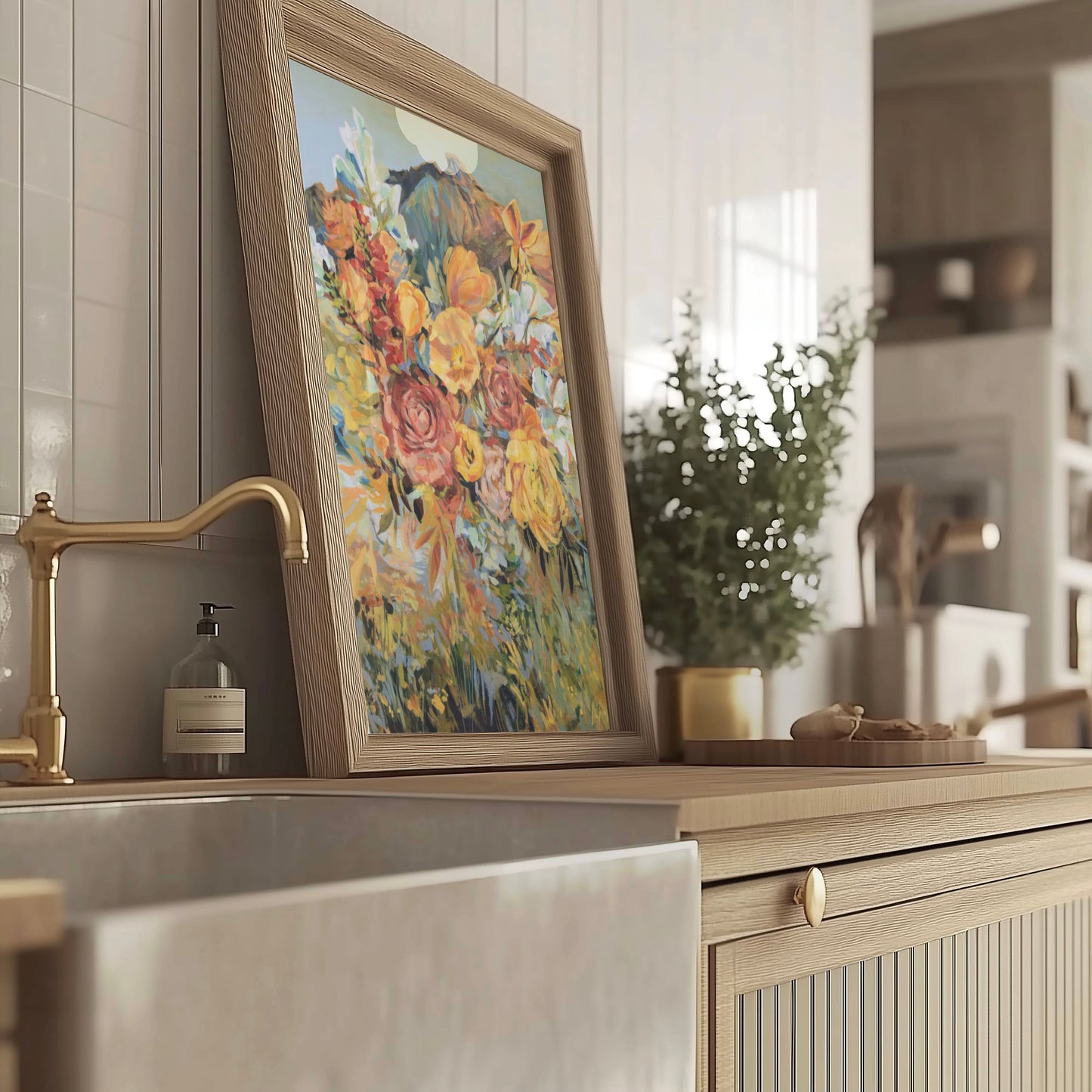 Kitchen counter with a floral painting, gold faucet, and green plant.