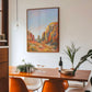 Dining room with a wooden table, chairs, and a large Arizona desert landscape painting on the wall.