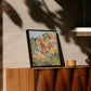 Framed artwork on a wooden surface with a neutral background