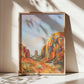 Framed painting of an Arizona desert landscape with orange cliffs and blue sky.